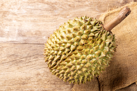Organic sweet durian fruit, Asian fruit, arranged on a wooden table, top view