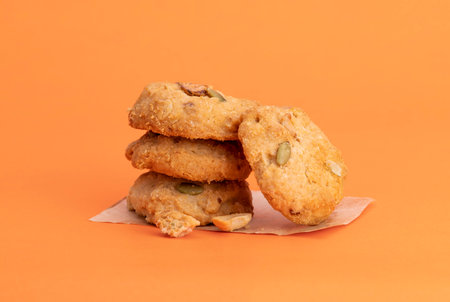 Delicious snack cookies, bakery dessert, isolated on orange background.の写真素材