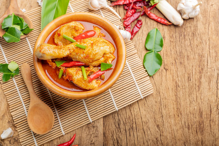 Chicken curry Asian food masala. Traditional cooking healthy food with spices. Arranged on wooden table background.の写真素材