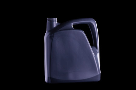 Black oil gallon or lubricant barrel or motor oil bottle isolated on black and dark background.の写真素材