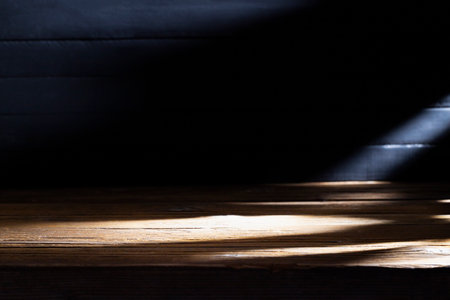 Old brown wooden floor or empty table with light coming from behind on a black and dark background.の写真素材
