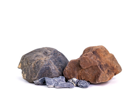 Natural rocks, black rough mountain rocks, red hard rocks for construction work on white background.