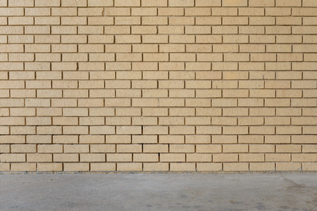 orange brick wall background intersect concrete floorの写真素材