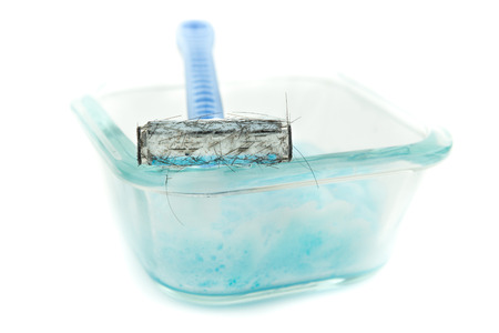 razor blades for being used men shaving on clear glass container and  blue shaving gel, foam, isolate backgroundの写真素材