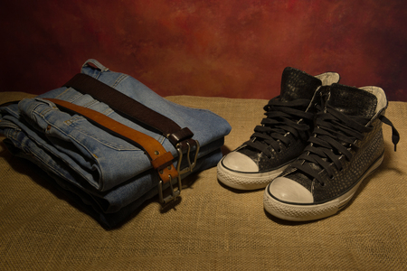 still life men accessories, black shoes, brown leather belt, jeans, bootsの写真素材
