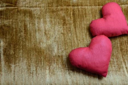 two red hearts on yellow corrugatedの写真素材