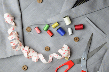 cutting, tailored equipments on double breasted suit, measurement tape, scissors, thread coil