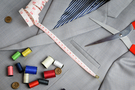 cutting, tailored equipments on double breasted suit, measurement tape, scissors, thread coil