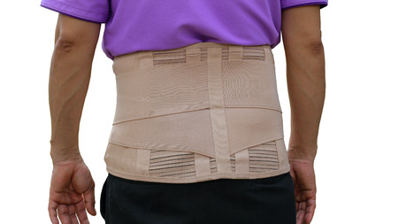Workers wear a back support belt for support to maintain gentle muscle on white background.の写真素材