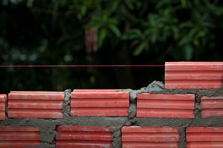 Mason brick walls were formed by using the work placement is patterned brick alternating rows up from the floor up. By a qualified technician.の写真素材