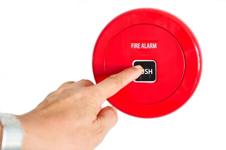 Hand pressing reset button fire alarm equipment on white background.の写真素材