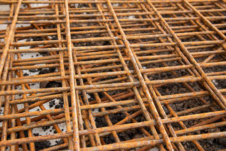 The rusty steel grid in pattern,Rusty construction metal mesh for  road infrastructure  metal rebar...