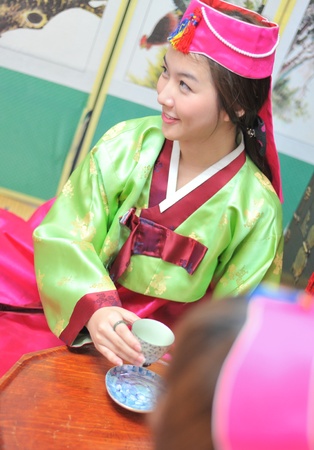 Woman asian drinking tea hanbok dress koreaの写真素材