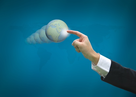 Business man pointing earth globes on world map backgroundの写真素材