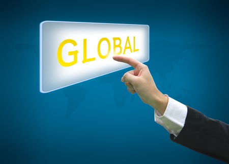 Business hand pointing global word on button with world map backgroundの写真素材