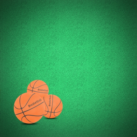 Basketball ball craft on green grass by cork boardの写真素材