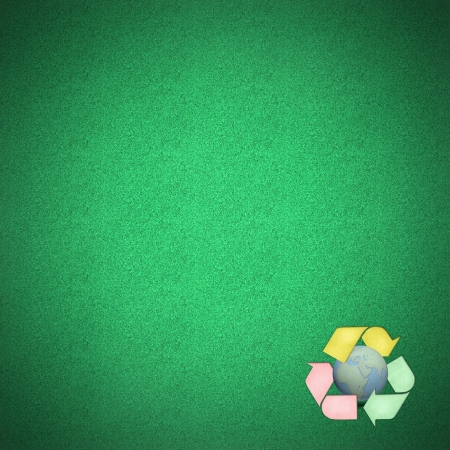 Color recycle logo with globes craft on green grass by cork boardの写真素材