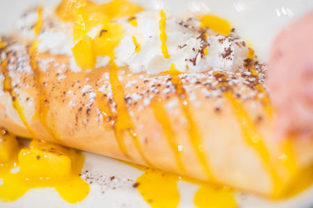 French crepe with mango and creamの写真素材