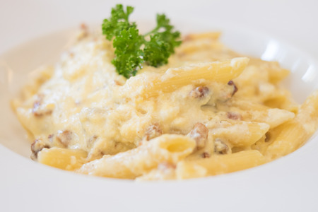 Penne carbonara closeup on top of a tableの写真素材