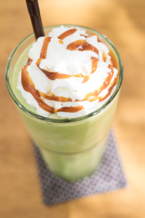 Green tean blended frappuccino on top with whipping creamの写真素材