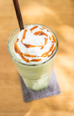 Green tean blended frappuccino on top with whipping creamの写真素材