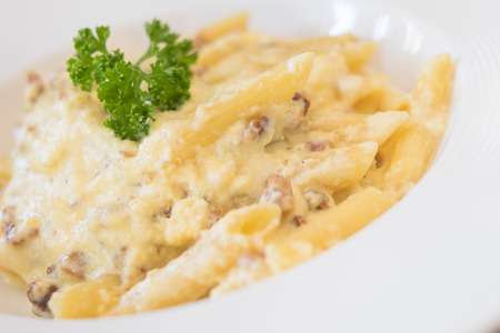 Penne carbonara closeup on top of a tableの写真素材