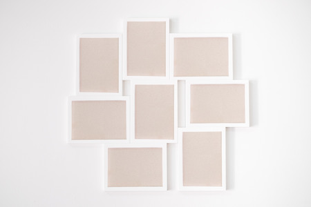 8 white wooden frame on white wallの写真素材