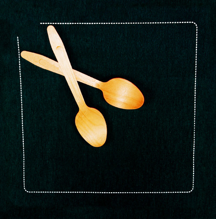 The wood spoons on a black napkinの写真素材