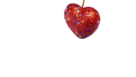 Glittered red heart, white background.の写真素材
