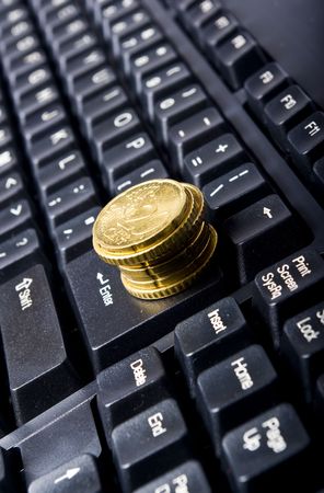 line of coins on keyboardの写真素材