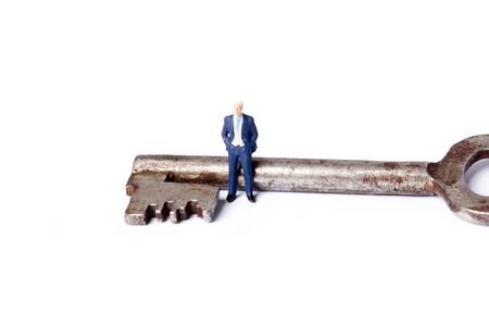 miniature man with keyの写真素材