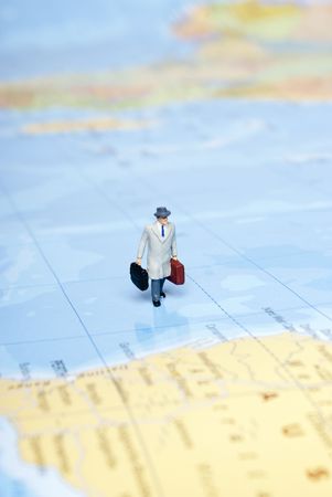 miniature man on world mapの写真素材