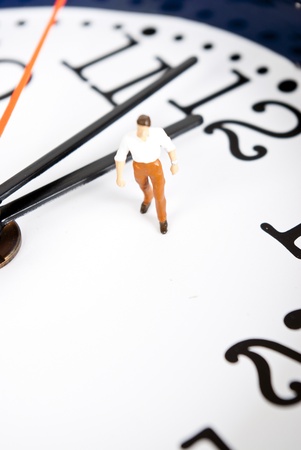 miniature man on the clockの写真素材
