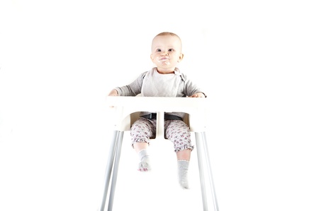 baby in seat and eatingの写真素材