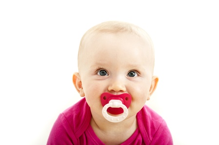baby child with dummy in her face