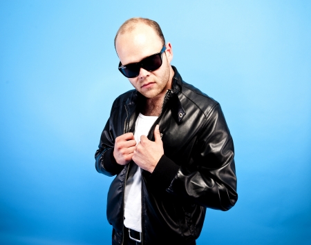 man in lether jacket on blue background の写真素材