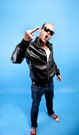 man in lether jacket on blue backgroundの写真素材