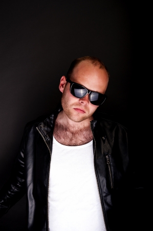 man in lether jacket on blue backgroundの写真素材