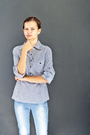 Teenager girl with blue shirt on black backgroundの写真素材