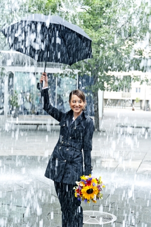 Woman with umbrella in the rainの写真素材