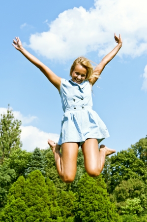 Beautiful young woman jump upの写真素材