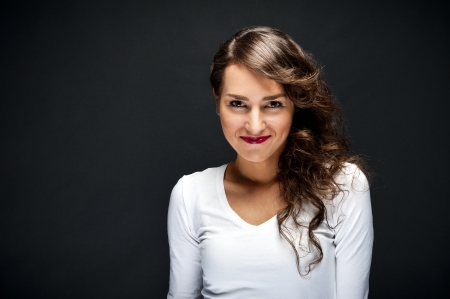 Woman with sensual smile on black backgroundの写真素材