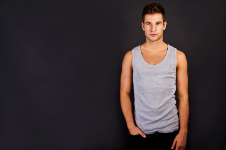 Man in the grey tank top shirt look at the camera