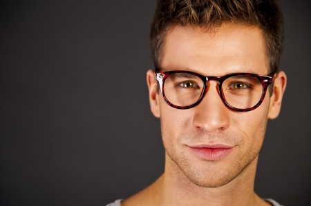 Man in the gray tank top shirt with glasses look at cameraの写真素材