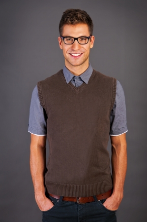 Man in blue sweter standing against the black backgroundの写真素材