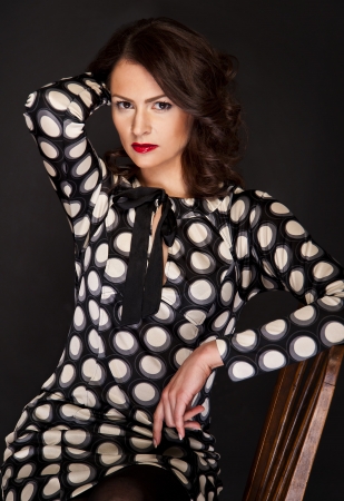 Woman in fashion set on black background with glamour lightの写真素材