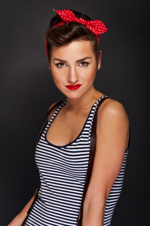 Pin-up woman with big smile on black backgroundの写真素材