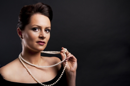 Fashion girl portrait with luxury accessories over black backgroundの写真素材