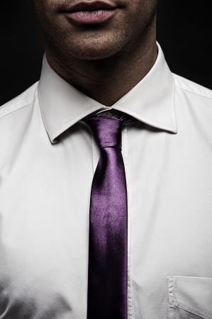 Man with white shirt and tie on black backgroundの写真素材