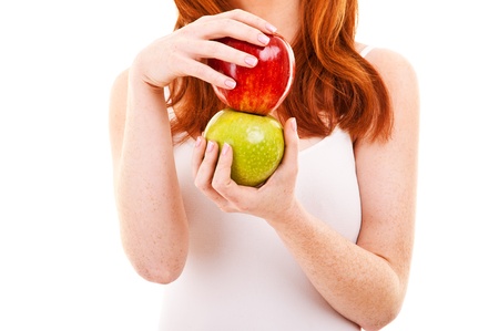 Red hair woman with green and red apple on whiteの写真素材